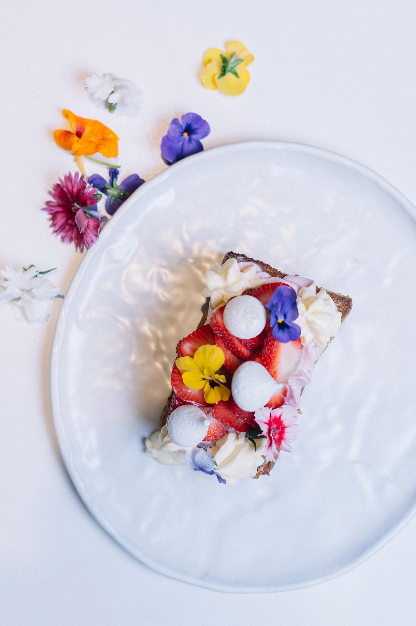 close-up plated dessert with edible flowers