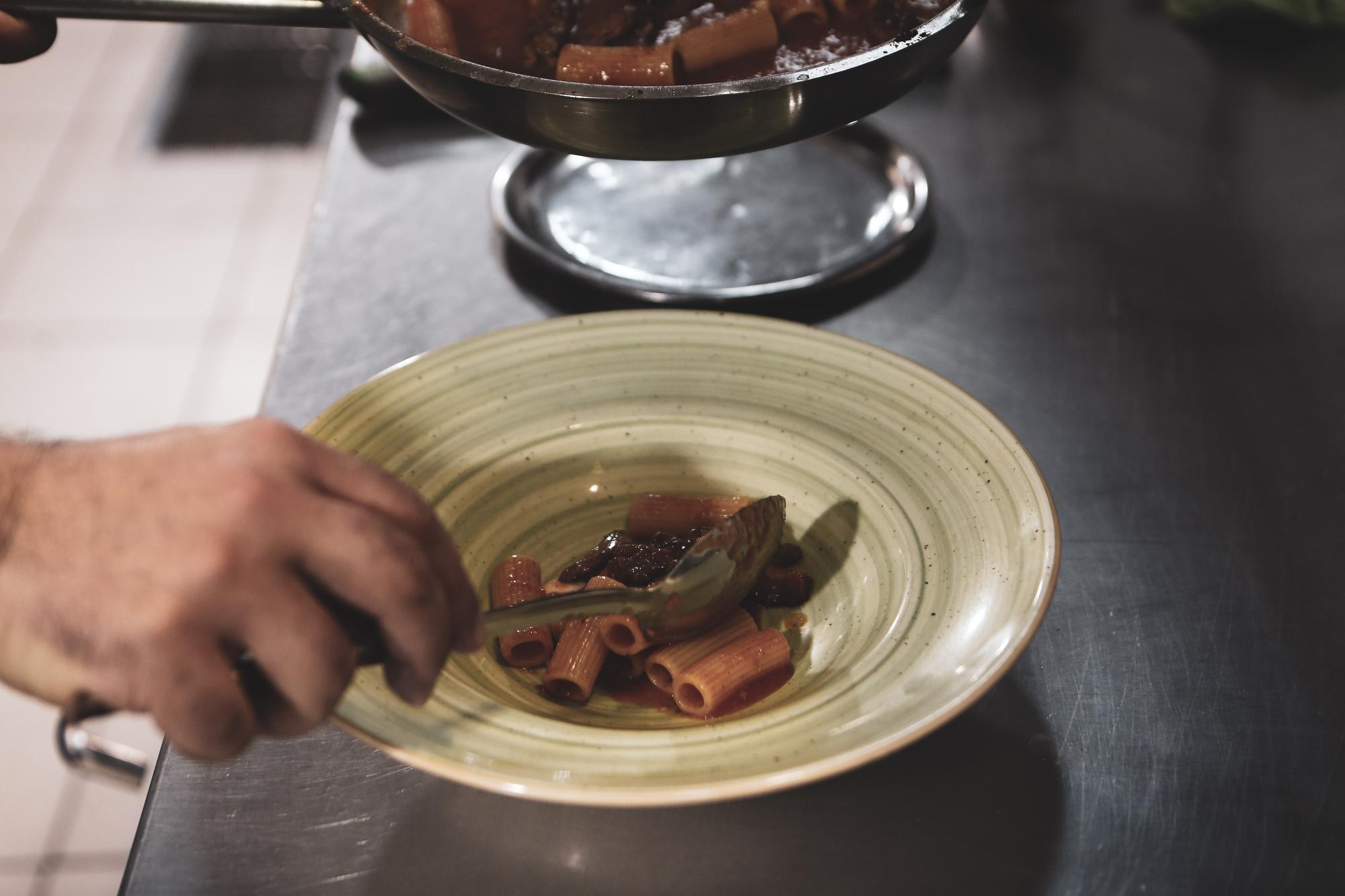 chef arranging plated seasonal dish on ceramic